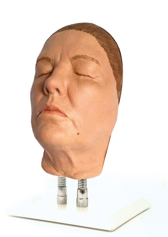 Modell av en kvinnas ansikte för injektionsträning